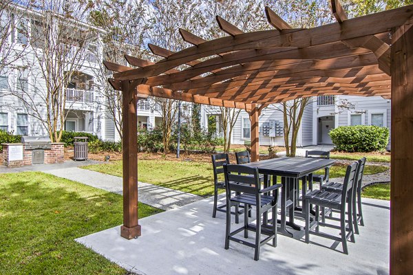 Spacious grill area and furnished patio at 1000 West Apartments, perfect for outdoor gatherings and leisure activities in a luxury setting