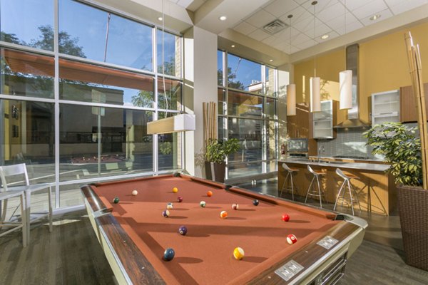 Vibrant game room with billiards and arcade games at Solera Apartments