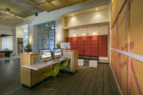 Modern business center with sleek workstations at Solera Apartments for productivity and collaboration