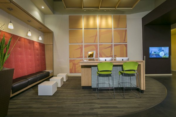 Business center with modern workstations at Solera Apartments, a Greystar luxury property