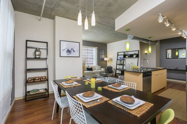 Modern dining room with elegant lighting and sleek furniture at Solera Apartments, showcasing contemporary design and comfort