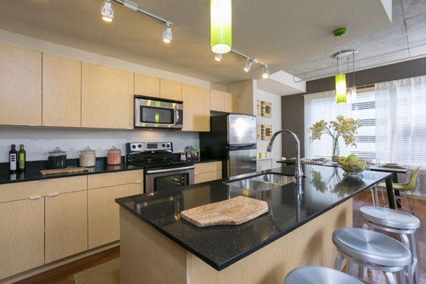 Modern kitchen featuring stainless steel appliances and granite countertops at Solera Apartments in luxury community