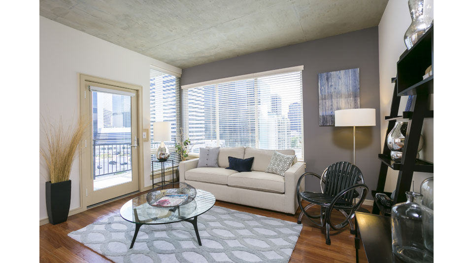 Spacious living room featuring modern decor and large windows at Solera Apartments, luxury residences by Greystar