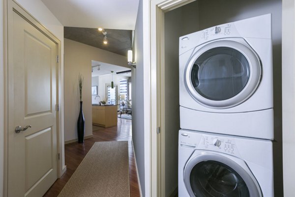 Laundry room with energy-efficient washers and dryers at Solera Apartments in Greystar's luxury apartment community