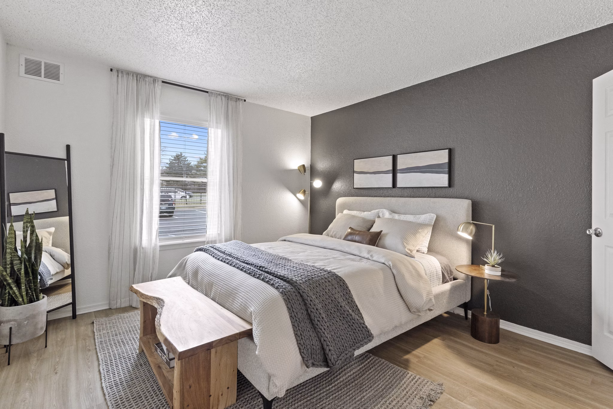 Modern bedroom with stylish decor and large windows at Coventry Park Apartments