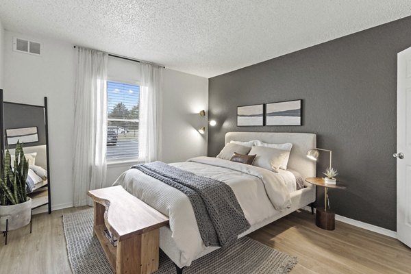 Modern bedroom with stylish decor and large windows at Coventry Park Apartments
