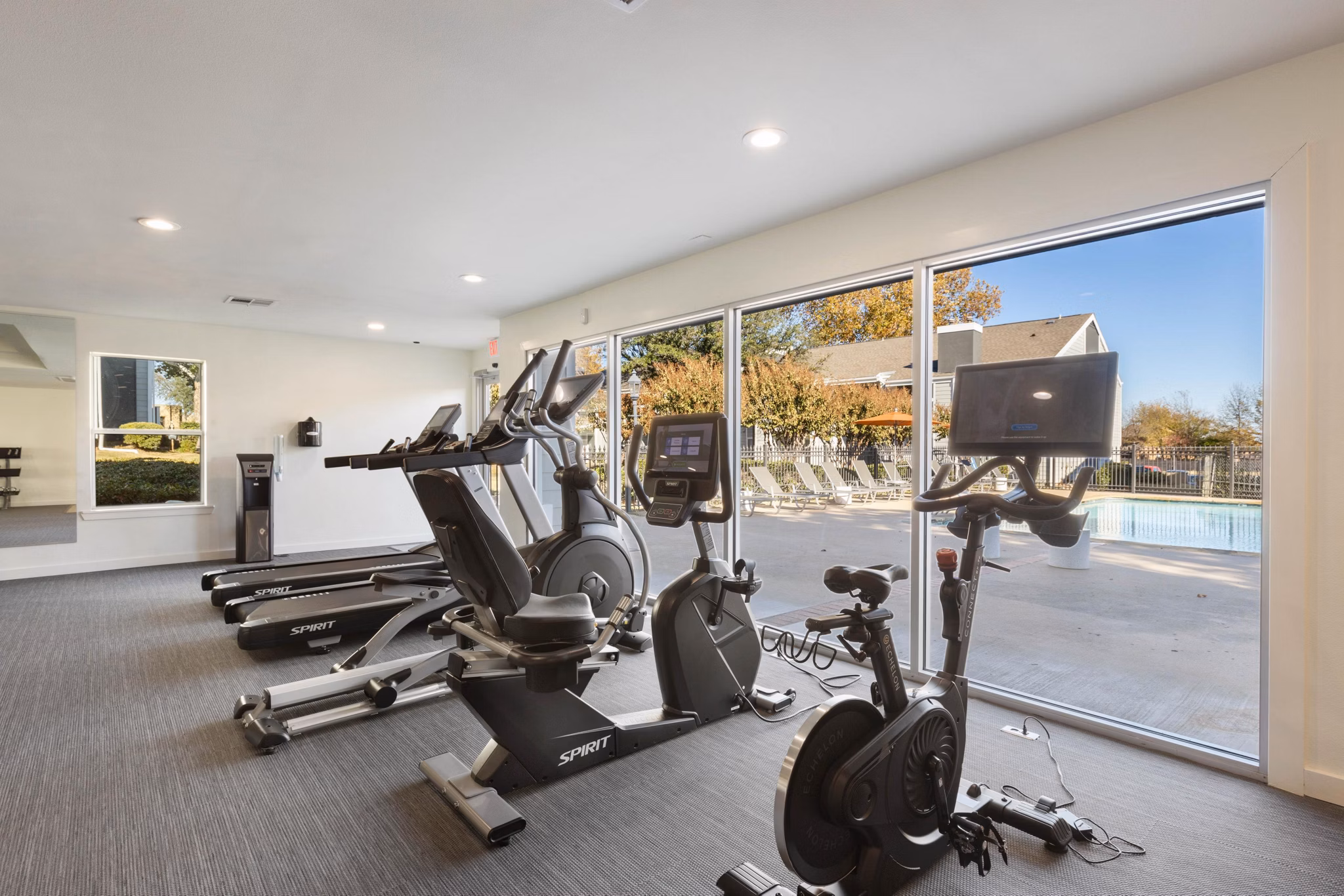 Modern fitness center with state-of-the-art equipment at Coventry Park Apartments featuring treadmill and weightlifting areas