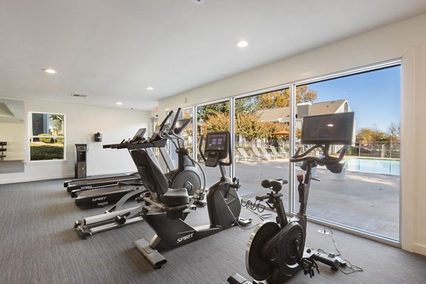 Modern fitness center with state-of-the-art equipment at Coventry Park Apartments featuring treadmill and weightlifting areas