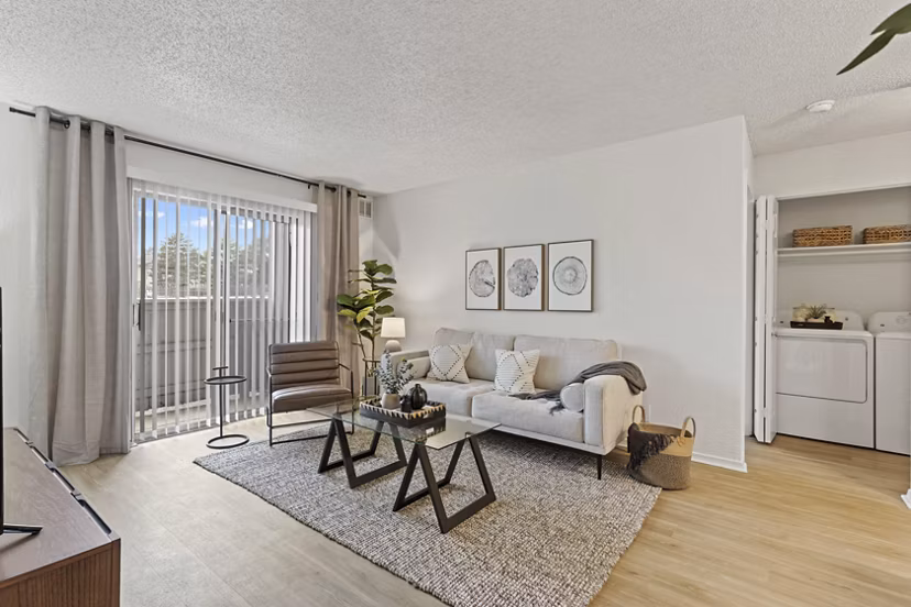 Spacious living room with modern decor in Coventry Park Apartments, featuring elegant furniture and natural lighting for a luxurious lifestyle