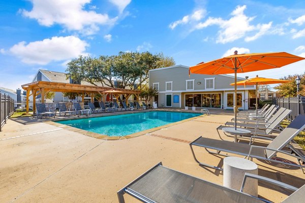 Luxurious pool with sun loungers at Coventry Park Apartments, a Greystar luxury living community
