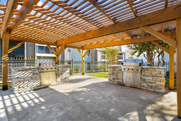 Outdoor grill area with modern seating at Coventry Park Apartments, a luxury community offering premium amenities and comfortable living spaces