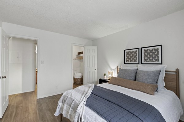 Cozy bedroom with plush bedding and natural light at Cascades at Southern Hills Apartments