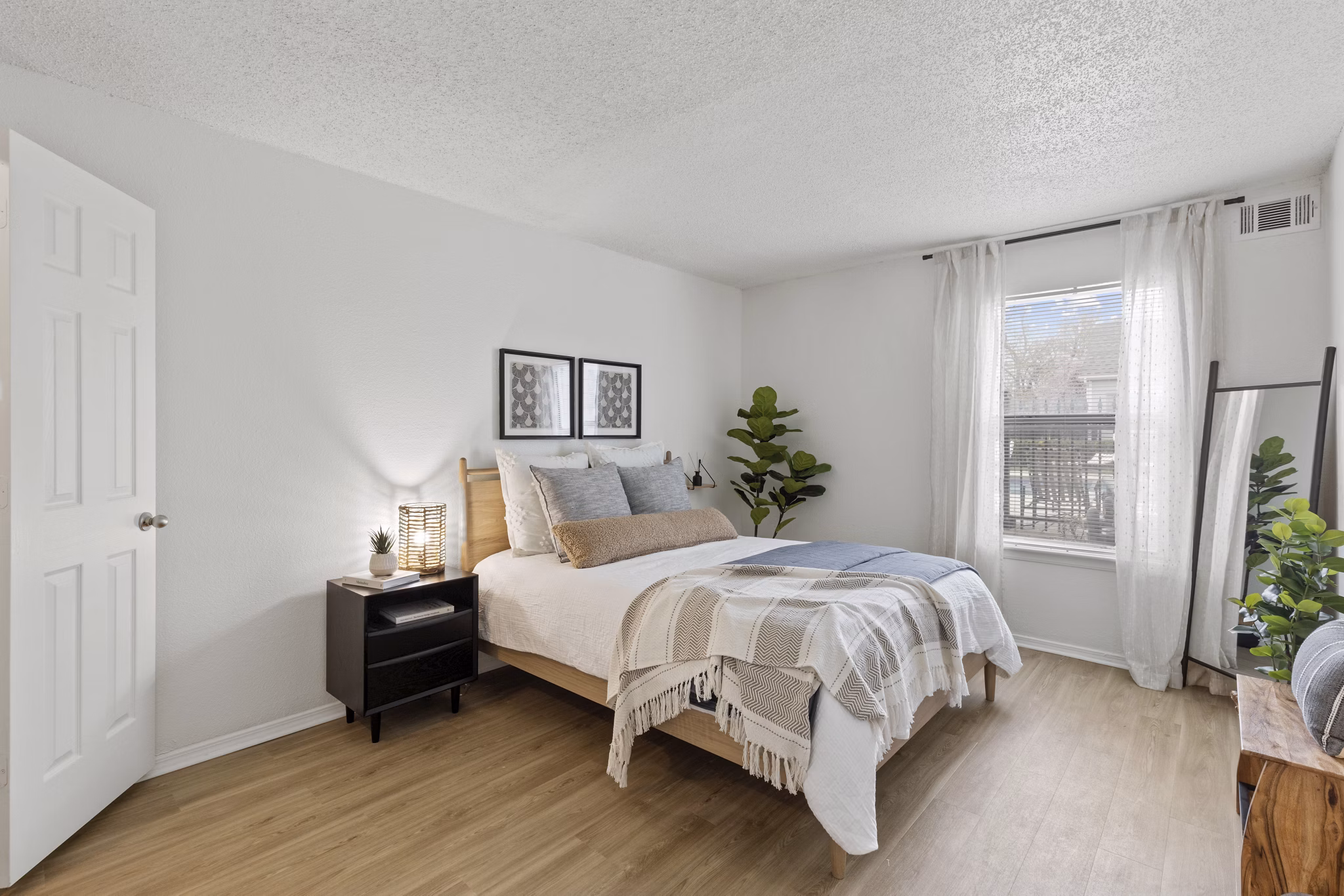Cozy bedroom with modern furnishings at Cascades at Southern Hills Apartments