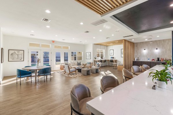 Clubhouse with modern design and cozy seating at Cascades at Southern Hills Apartments