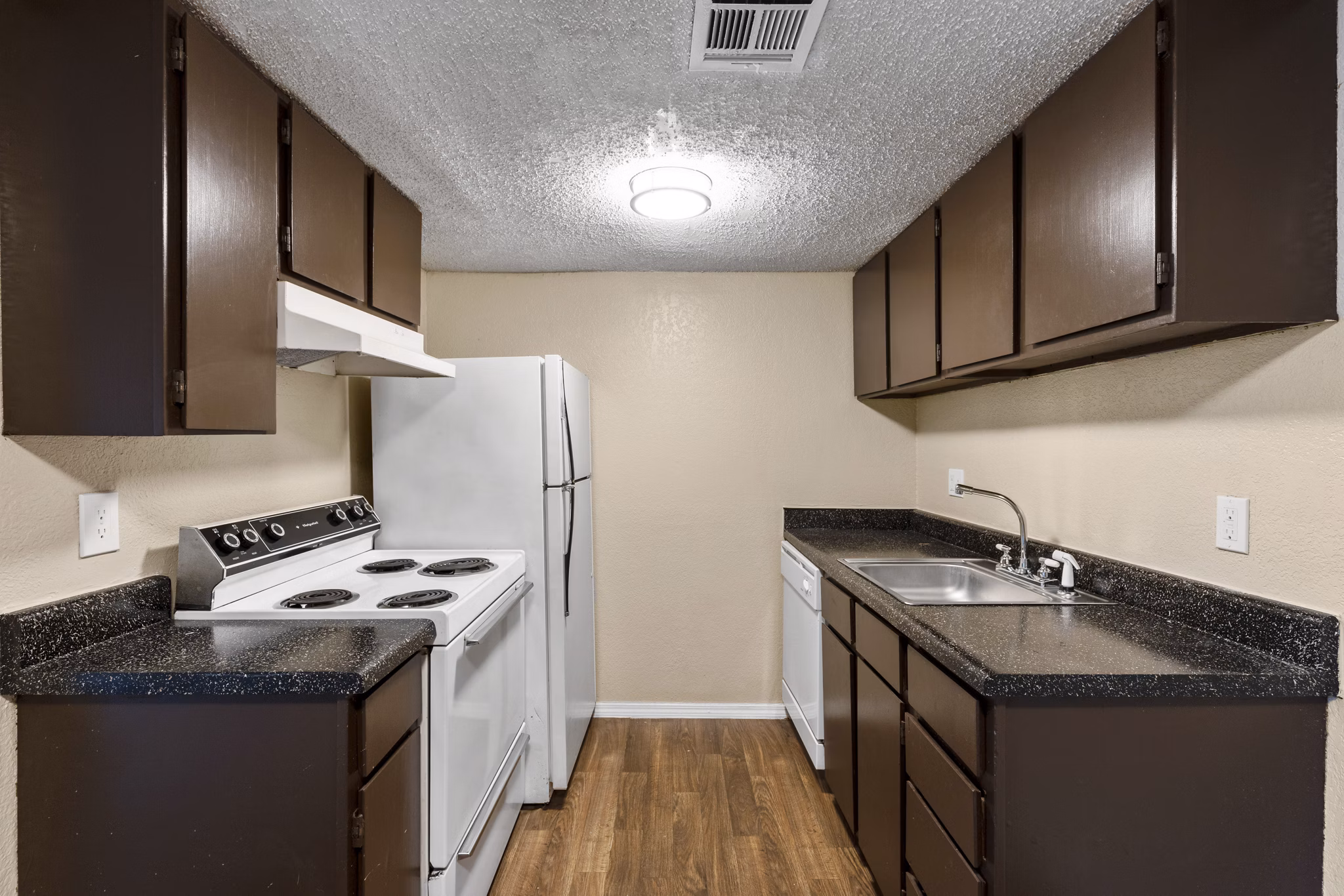 Modern kitchen with stainless steel appliances at Cascades at Southern Hills Apartments