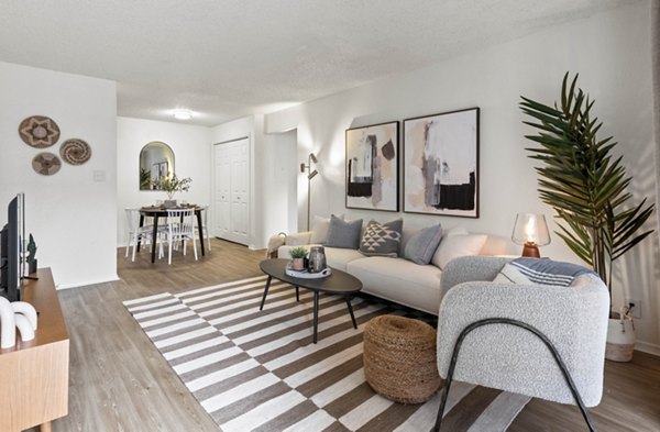 Stylish living room with plush seating and modern decor at Cascades at Southern Hills Apartments, Greystar luxury apartments