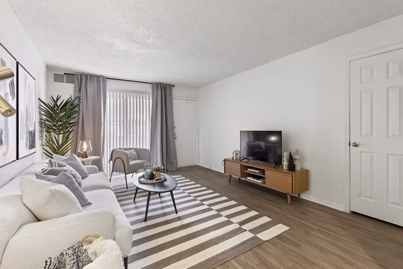 Spacious living room with modern decor and natural light in Cascades at Southern Hills Apartments