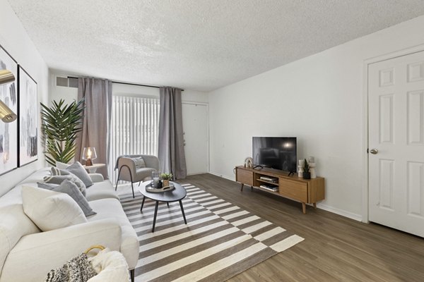 Spacious living room with modern decor and natural light in Cascades at Southern Hills Apartments
