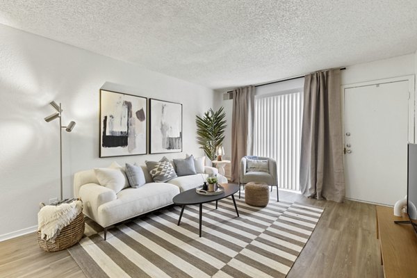 Spacious living room with modern decor in Cascades at Southern Hills Apartments