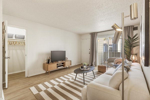 Spacious living room with modern decor and natural lighting in Cascades at Southern Hills Apartments
