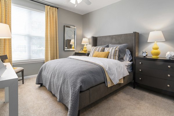 Spacious bedroom featuring modern design and ample natural light at Oberlin Court Apartments luxury apartments