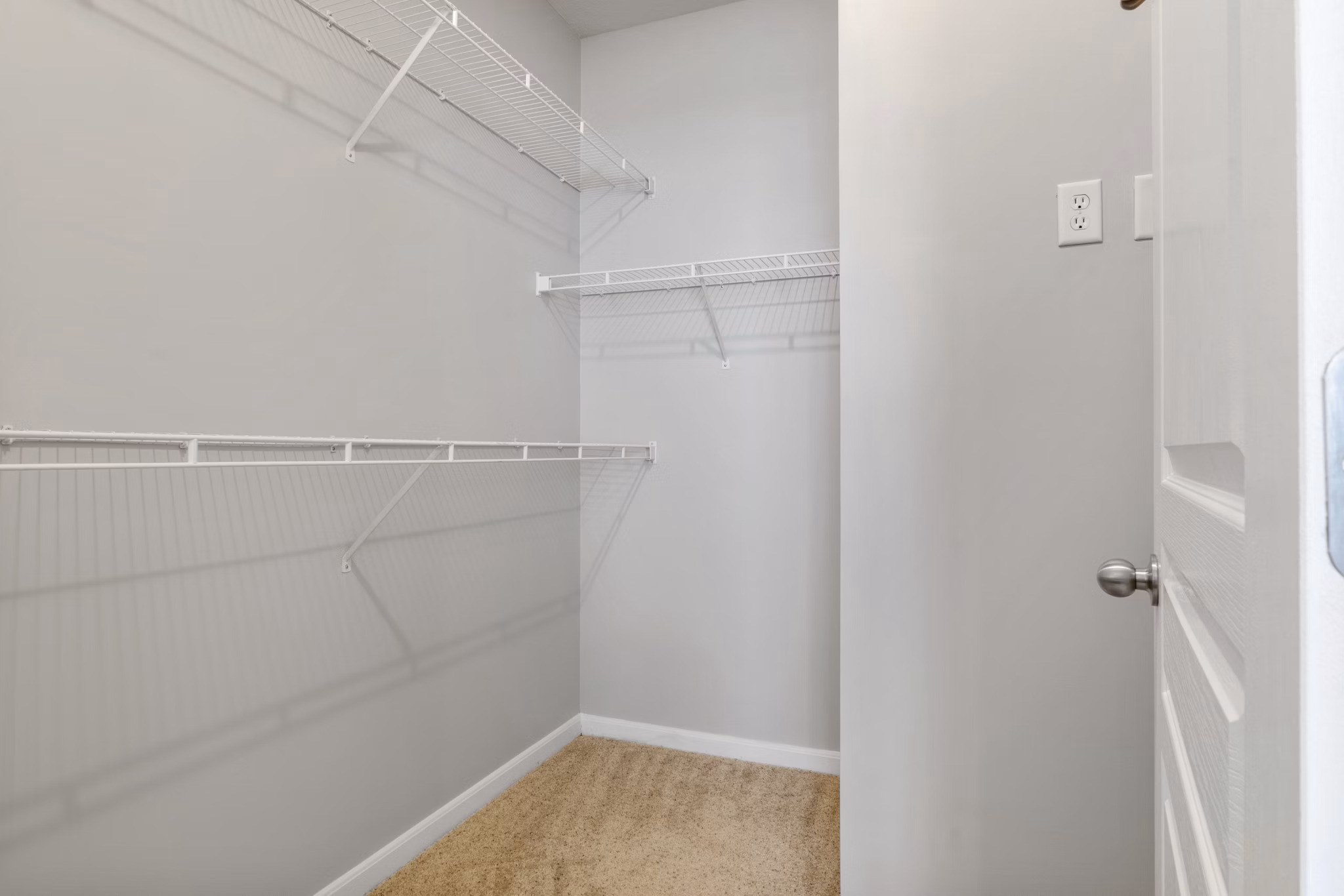Walk-in closet with ample shelving and storage space in Oberlin Court Apartments, ideal for organizing luxury living items