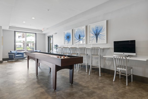 Vibrant game room with pool table and lounge area at Oberlin Court Apartments, offering luxury living amenities for residents