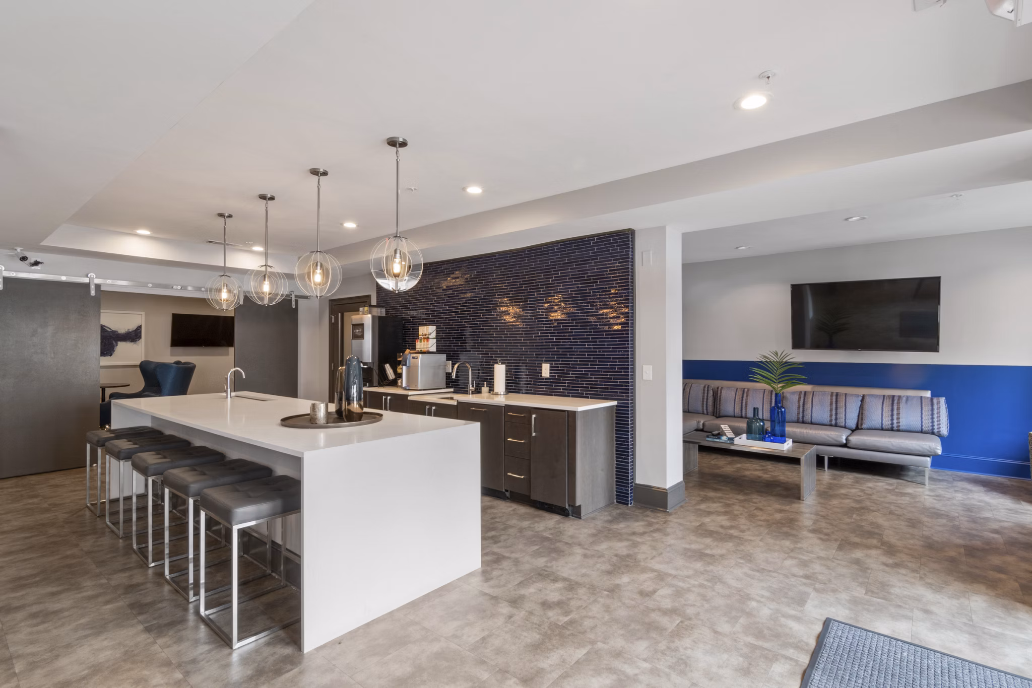 Clubhouse featuring upscale lounge seating and bar at Oberlin Court Apartments, luxury living by Greystar