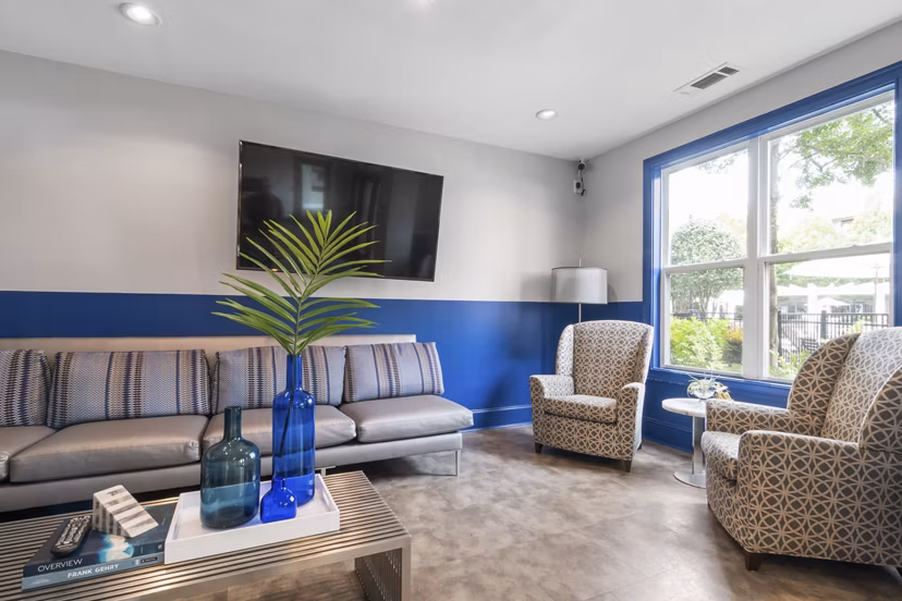 Modern clubhouse featuring cozy lounge seating and a fireplace at Oberlin Court Apartments, perfect for luxury living