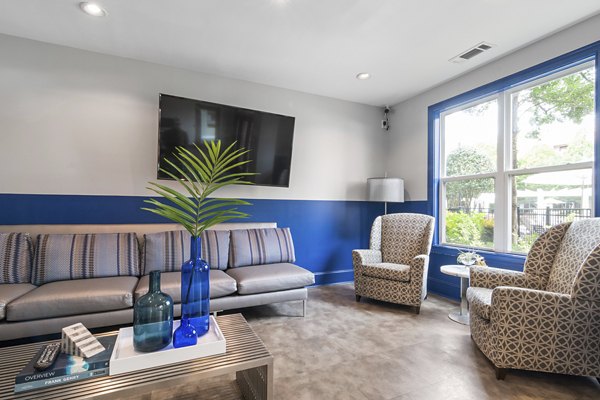 Modern clubhouse featuring cozy lounge seating and a fireplace at Oberlin Court Apartments, perfect for luxury living