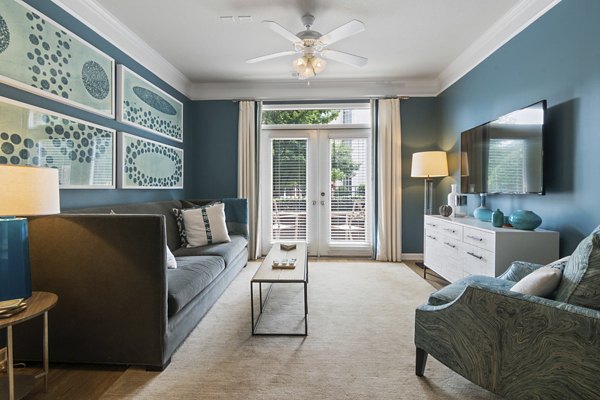Spacious living room with modern decor at Oberlin Court Apartments, featuring luxury finishes and comfortable seating for a stylish living experience