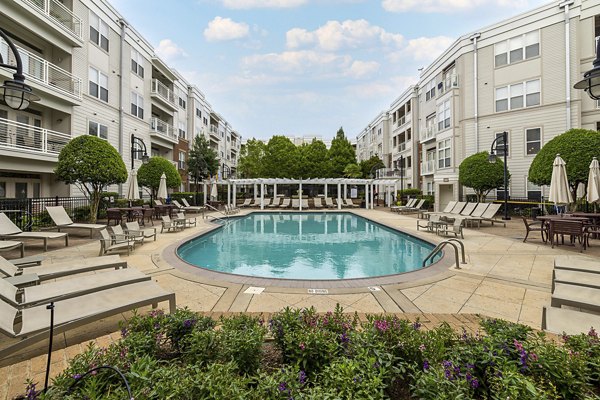 Relaxing pool area surrounded by lush landscaping at Oberlin Court Apartments, perfect for unwinding in a luxury setting
