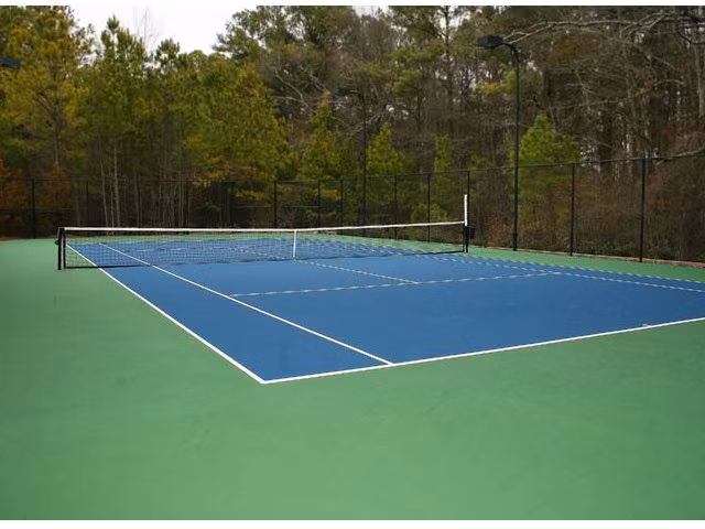 Outdoor tennis court at Villas at Loganville providing luxury sports amenities
