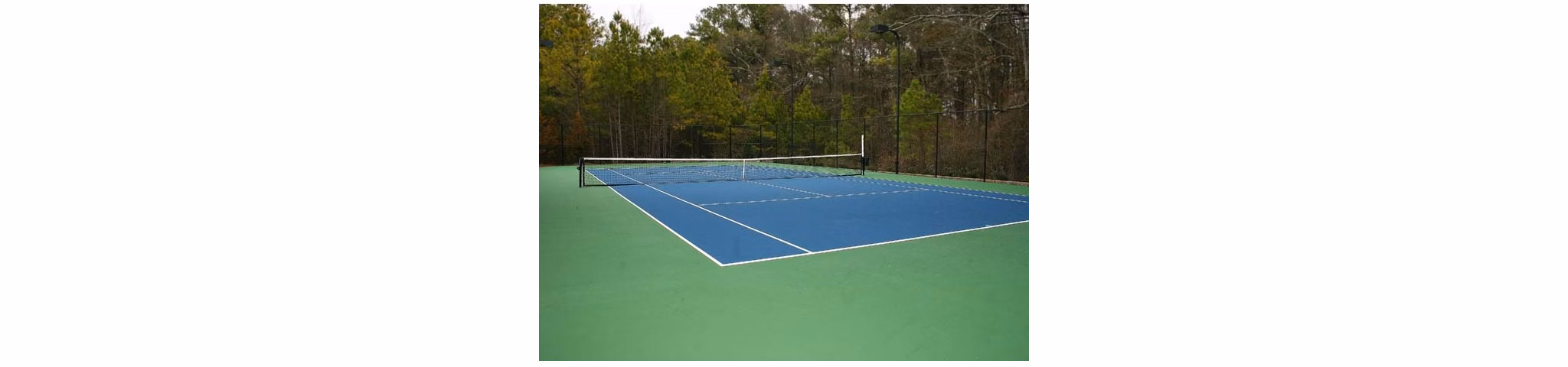 Outdoor tennis court at Villas at Loganville providing luxury sports amenities