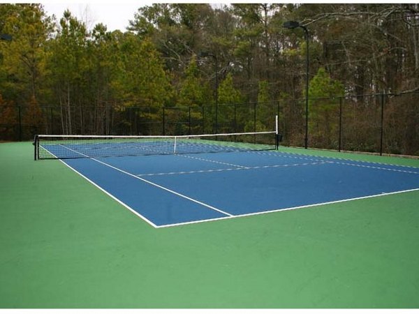 Outdoor tennis court at Villas at Loganville providing luxury sports amenities