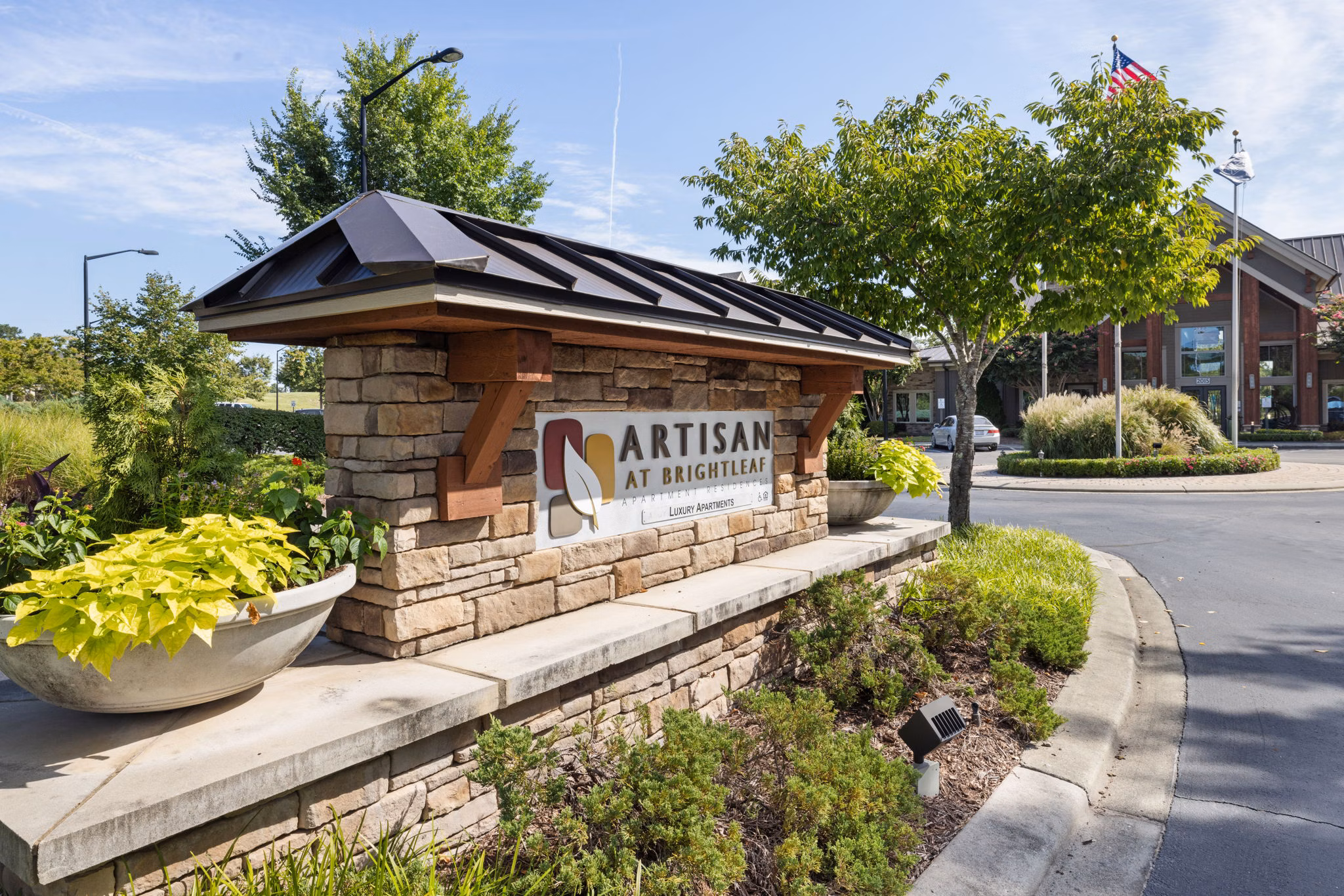 Artisan at Brightleaf Apartments: Signage highlighting luxury apartment living in vibrant surroundings