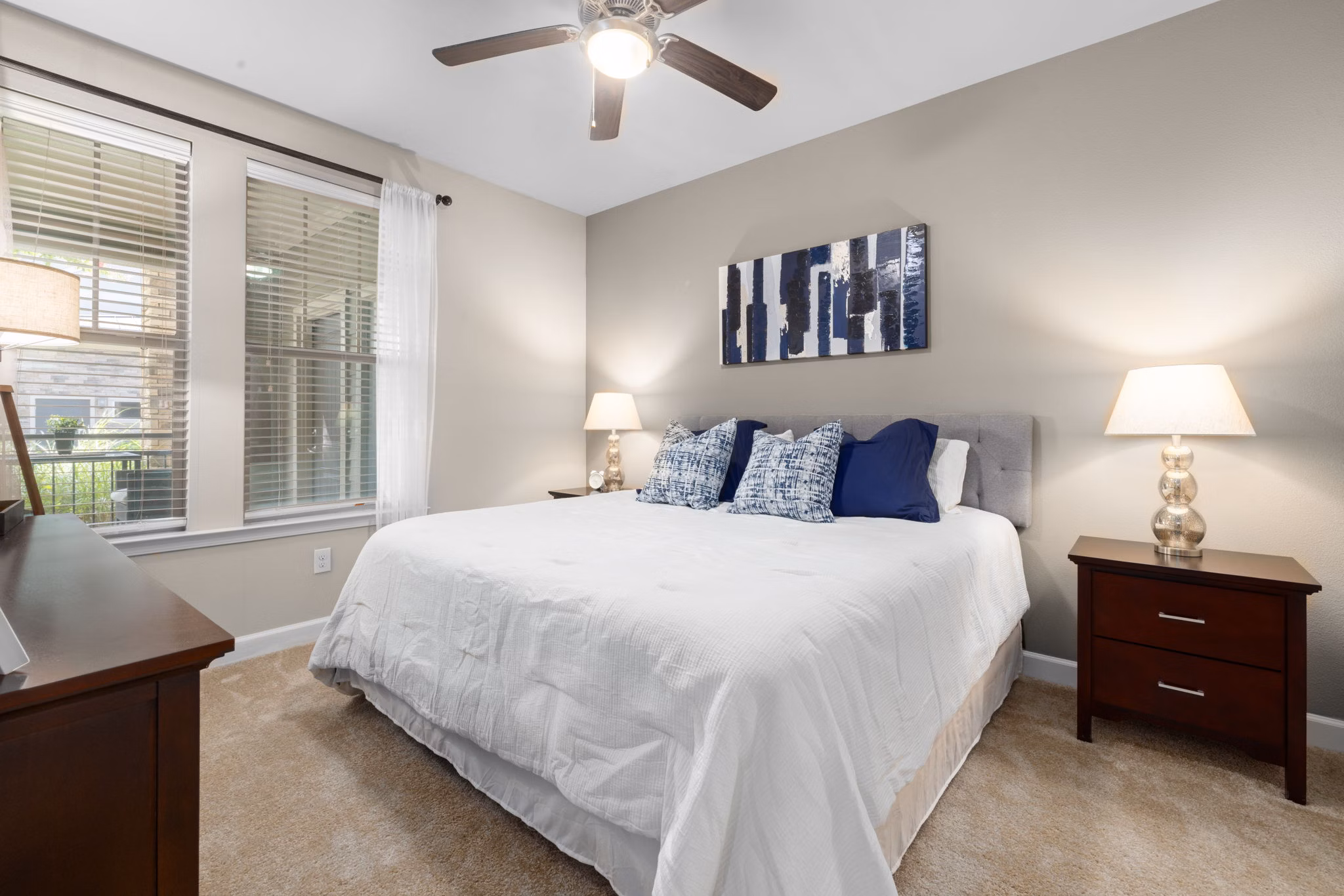 Bedroom featuring modern decor and large windows in Artisan at Brightleaf Apartments
