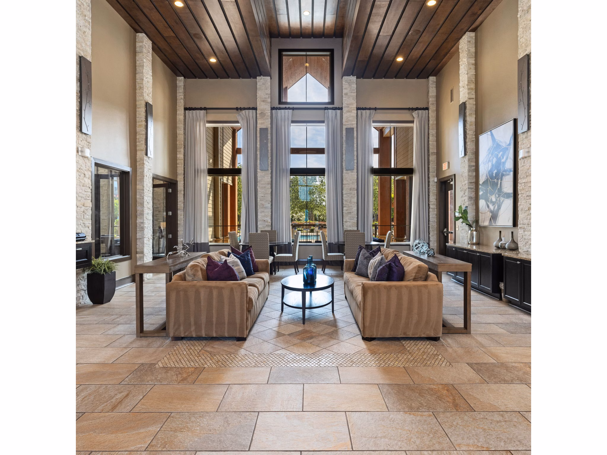 Modern clubhouse with lounge seating and fireplace at Artisan at Brightleaf Apartments