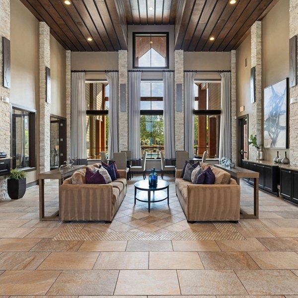 Modern clubhouse with lounge seating and fireplace at Artisan at Brightleaf Apartments