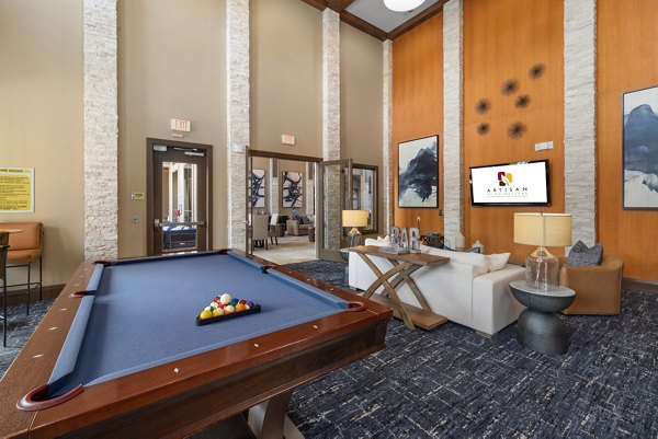 Game room with modern decor and pool table at Artisan at Brightleaf Apartments