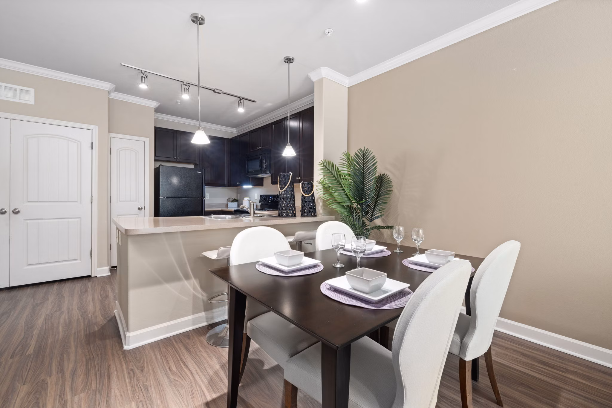 Dining room featuring elegant dining set and modern lighting in Artisan at Brightleaf Apartments