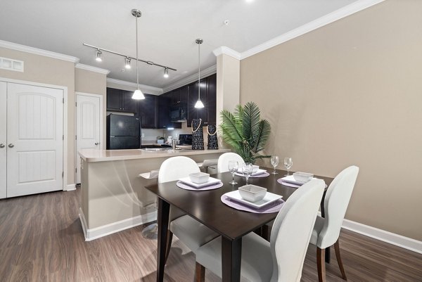 Dining room featuring elegant dining set and modern lighting in Artisan at Brightleaf Apartments