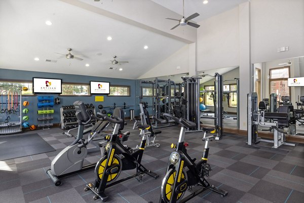 State-of-the-art fitness center at Artisan at Brightleaf Apartments with cardio and strength training equipment