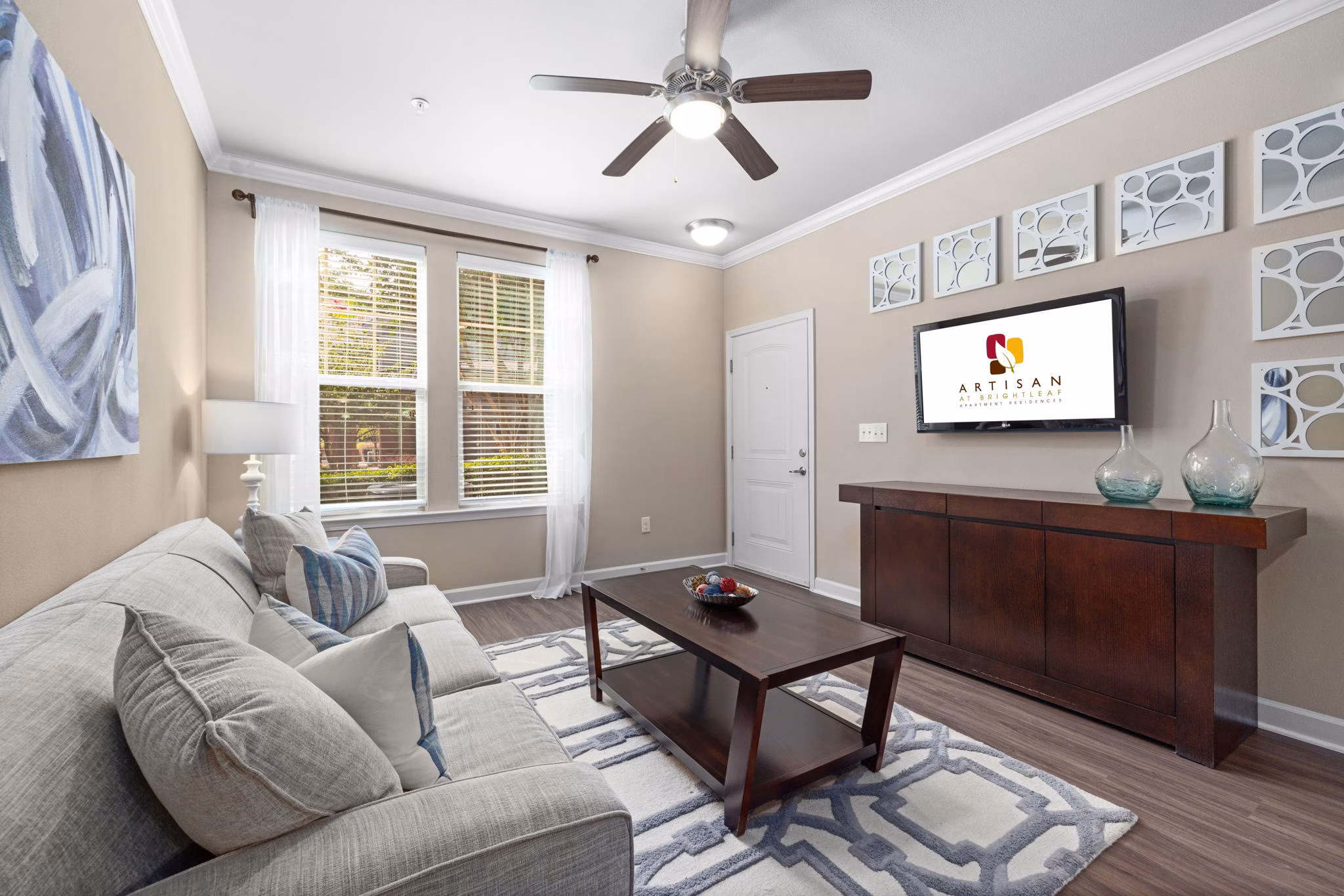 Spacious living room with contemporary decor in Artisan at Brightleaf Apartments