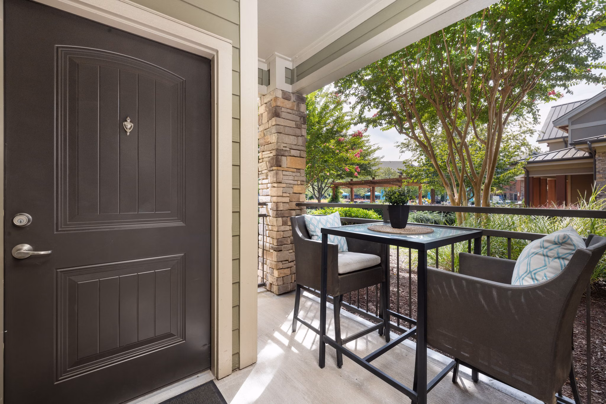 Balcony with seating and garden view at Artisan at Brightleaf Apartments, a luxury living space