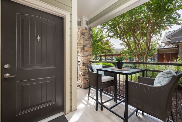 Balcony with seating and garden view at Artisan at Brightleaf Apartments, a luxury living space