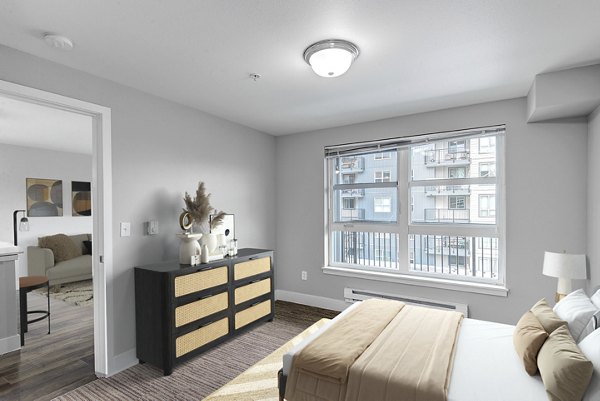 Spacious bedroom with lake views at 1611 on Lake Union Apartments, featuring modern decor and large windows