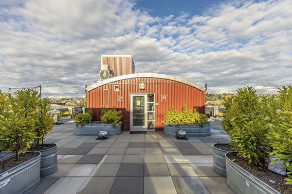 Green courtyard with seating at 1611 on Lake Union Apartments, providing a serene outdoor space in a luxury living environment