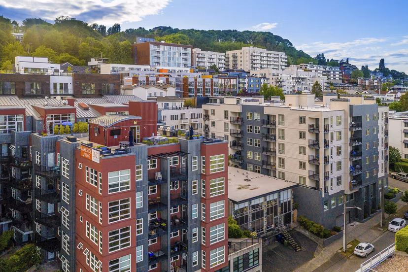 View of 1611 on Lake Union Apartments: Luxury waterside high-rise in Seattle, featuring balconies and stunning city skyline backdrop
