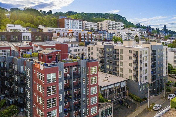 View of 1611 on Lake Union Apartments: Luxury waterside high-rise in Seattle, featuring balconies and stunning city skyline backdrop